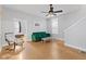 Living room with hardwood floors, green couch, and an armchair at 128 Wisconsin St, Indianapolis, IN 46225