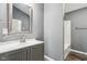 Bathroom with gray walls, wood-look floors, vanity, and shower/tub combo at 1418 S New Jersey St, Indianapolis, IN 46225