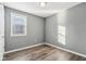 Small bedroom with gray walls, wood-look floors, and a window with blinds at 1418 S New Jersey St, Indianapolis, IN 46225