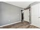 Bright bedroom with gray walls, wood-look floors, and access to other rooms at 1418 S New Jersey St, Indianapolis, IN 46225