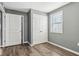 Bedroom with gray walls, wood-look floors, and double-door closet at 1418 S New Jersey St, Indianapolis, IN 46225