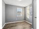 Bright bedroom with gray walls, wood-look floors, and a window with blinds at 1418 S New Jersey St, Indianapolis, IN 46225