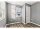 Spacious bedroom with gray walls, wood-look floors, and a window with blinds at 1418 S New Jersey St, Indianapolis, IN 46225