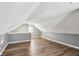 Spacious bonus room with sloped ceilings and wood flooring at 1418 S New Jersey St, Indianapolis, IN 46225