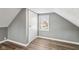 Charming dormer bedroom with gray walls, wood-look flooring, and a window at 1418 S New Jersey St, Indianapolis, IN 46225