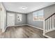 Gray living room with wood-look floors and staircase at 1418 S New Jersey St, Indianapolis, IN 46225