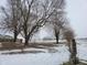 Snowy backyard with a view of the house and farm at 1545 S Us 421, Zionsville, IN 46077