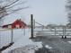 Open gate leading to a red barn and snowy landscape at 1545 S Us 421, Zionsville, IN 46077