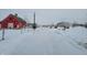 Snowy driveway leading to a red barn and other buildings at 1545 S Us 421, Zionsville, IN 46077