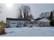 Ranch-style home with attached garage; snowy front yard at 1545 S Us 421, Zionsville, IN 46077