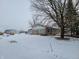 Cozy ranch home with a snowy yard and outbuildings at 1545 S Us 421, Zionsville, IN 46077