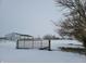 Gate to a snowy farm field, with a barn in the distance at 1545 S Us 421, Zionsville, IN 46077