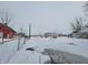 Rural property featuring a ranch home, red barn, and snow-covered grounds at 1545 S Us 421, Zionsville, IN 46077
