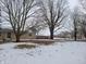 Brick ranch house with a covered porch, nestled amongst bare trees at 1545 S Us 421, Zionsville, IN 46077