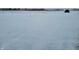 Open snowy field with distant trees and a hay bale at 1545 S Us 421, Zionsville, IN 46077