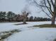 A partially snow covered yard with a large leafless tree in the winter at 1545 S Us 421, Zionsville, IN 46077