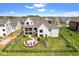 Aerial view of a home with a beautiful backyard, patio, outdoor fire pit, and well-maintained landscaping at 15844 Nocturne Dr, Westfield, IN 46074
