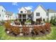 Backyard view showing outdoor firepit, covered patio and manicured lawn at 15844 Nocturne Dr, Westfield, IN 46074