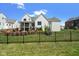 Spacious backyard featuring a well-maintained lawn, garden beds, and an elegant iron fence for privacy at 15844 Nocturne Dr, Westfield, IN 46074
