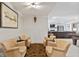 Basement lounge area featuring comfortable armchairs, decorative elements, and seamless access to a recreation space at 15844 Nocturne Dr, Westfield, IN 46074