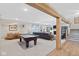 Finished basement with a billiard table, fireplace, seating area, and stairs to the upper level at 15844 Nocturne Dr, Westfield, IN 46074