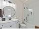 Well-lit bathroom showcasing a modern vanity and a bathtub with a white subway tile surround and glass door at 15844 Nocturne Dr, Westfield, IN 46074