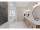 A luxury bathroom featuring double vanity sinks and a standalone tub with bright natural light at 15844 Nocturne Dr, Westfield, IN 46074