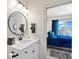 Well-lit bathroom connected to a bedroom, showcasing a round mirror, white vanity, and modern fixtures at 15844 Nocturne Dr, Westfield, IN 46074