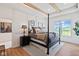 Bedroom featuring a four-poster bed, wood floors, and bright natural light at 15844 Nocturne Dr, Westfield, IN 46074