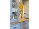 Stylish blue cabinetry with glass fronts showcases glassware and storage solutions in the kitchen area at 15844 Nocturne Dr, Westfield, IN 46074