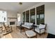 Covered porch area with brick fireplace, modern furniture set, overhead lighting, and large windows at 15844 Nocturne Dr, Westfield, IN 46074