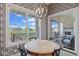 Cozy dining area with a round table, stylish wallpaper, and scenic views from large windows at 15844 Nocturne Dr, Westfield, IN 46074
