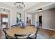 Open dining space featuring a rustic table, modern chandelier, and seamless access to other living spaces at 15844 Nocturne Dr, Westfield, IN 46074