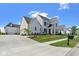 Elegant two-story white brick home with a three-car garage, beautiful landscaping, and a concrete driveway at 15844 Nocturne Dr, Westfield, IN 46074