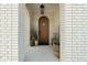 Arched wood front door framed by brick archway and decorative plants at 15844 Nocturne Dr, Westfield, IN 46074