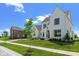 Charming two-story white brick home with a manicured lawn, mature trees, and a welcoming entrance at 15844 Nocturne Dr, Westfield, IN 46074