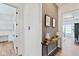Elegant hallway with decorative console table, artwork, and seamless flow to adjacent rooms at 15844 Nocturne Dr, Westfield, IN 46074