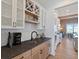 Well-equipped kitchen area featuring modern appliances, wooden cabinetry, and a convenient wet bar area at 15844 Nocturne Dr, Westfield, IN 46074
