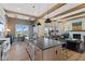 Open-concept kitchen featuring a large island with seating, stylish light fixtures, and a dining area at 15844 Nocturne Dr, Westfield, IN 46074