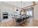 Modern kitchen with white cabinetry, a large island with bar seating, and stainless steel appliances at 15844 Nocturne Dr, Westfield, IN 46074