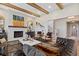 Elegant living room showcasing exposed wooden beams, a brick fireplace, and stylish furnishings at 15844 Nocturne Dr, Westfield, IN 46074