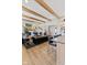 Open-concept living room featuring exposed beams, a fireplace, and seamless flow to the kitchen at 15844 Nocturne Dr, Westfield, IN 46074