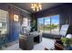 An elegant office featuring navy walls, wood desk, and a large window with neighborhood views at 15844 Nocturne Dr, Westfield, IN 46074