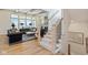 Open-concept living area with a staircase featuring wood and metal railings and stylish furnishings at 15844 Nocturne Dr, Westfield, IN 46074