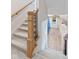 Carpeted staircase with wooden banister, leading down to a stylish lower level with artwork at 15844 Nocturne Dr, Westfield, IN 46074