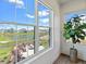 A picturesque view from the home's windows, overlooking a pond and outdoor lounge area at 15844 Nocturne Dr, Westfield, IN 46074