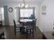 Bright dining room features round table with four chairs, hardwood floors, and access to sunroom at 173 Megan Way, Cumberland, IN 46229