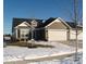 Ranch style home with two-car garage and snow-covered landscaping at 173 Megan Way, Cumberland, IN 46229