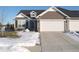 Exterior of charming ranch home with two-car garage and snow-covered lawn at 173 Megan Way, Cumberland, IN 46229