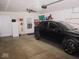 Garage interior with car, storage, and ceiling fan at 173 Megan Way, Cumberland, IN 46229